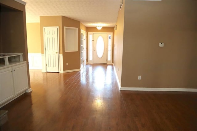 foyer with wood finished floors and baseboards