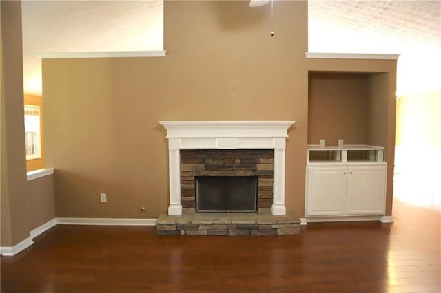 unfurnished living room with baseboards, wood finished floors, and a fireplace