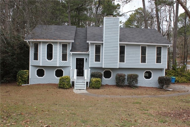 raised ranch with a front yard