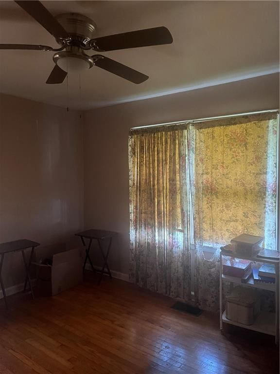 spare room with ceiling fan and dark hardwood / wood-style flooring