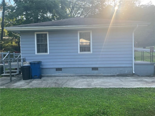 view of side of property with a yard and a patio area