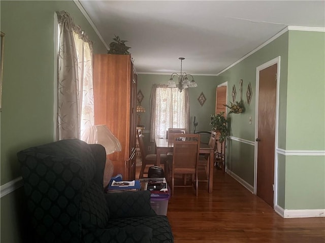 dining space with ornamental molding, dark hardwood / wood-style floors, and an inviting chandelier