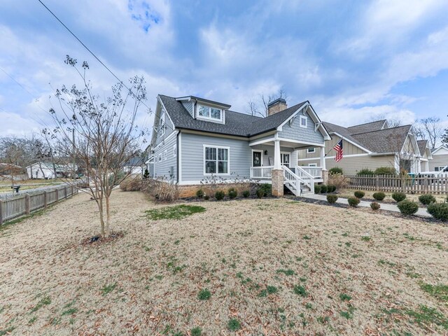 craftsman inspired home featuring a front yard and covered porch