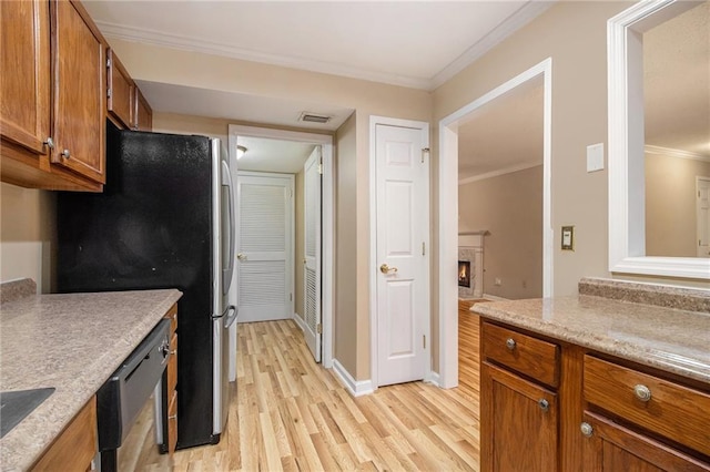 205 Peachtree Forest Ter, Peachtree Corners, GA 30092 - kitchen with dishwashing machine, light wood-type flooring, freestanding refrigerator, brown cabinetry, and crown molding