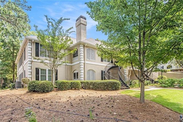 205 Peachtree Forest Ter, Peachtree Corners, GA 30092 - view of front of home with stairs, stucco siding, and a chimney
