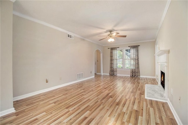 205 Peachtree Forest Ter, Peachtree Corners, GA 30092 - unfurnished living room featuring arched walkways, a ceiling fan, light wood-style flooring, a fireplace, and crown molding