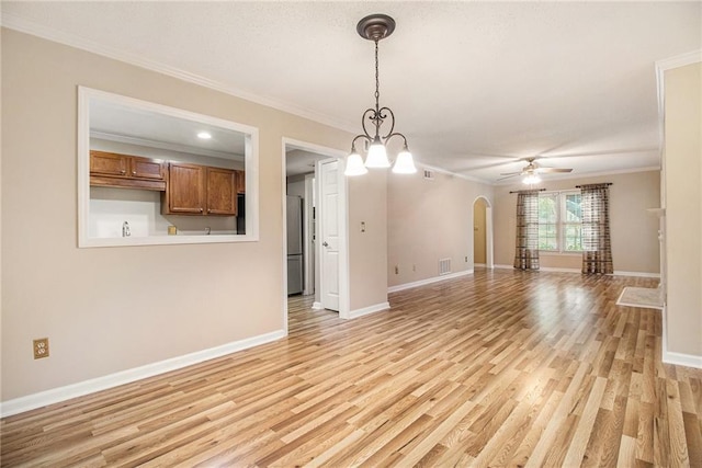 205 Peachtree Forest Ter, Peachtree Corners, GA 30092 - unfurnished living room featuring arched walkways, crown molding, light wood-style flooring, and a ceiling fan
