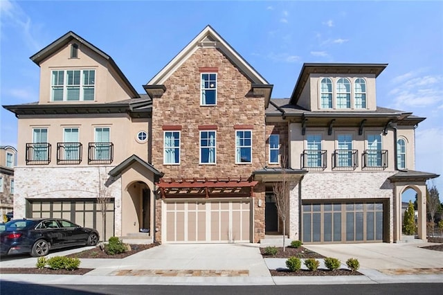 townhome / multi-family property with a balcony, concrete driveway, and a garage