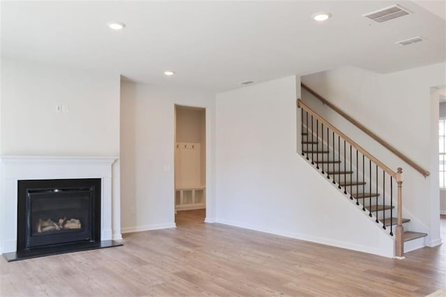 unfurnished living room with light hardwood / wood-style flooring