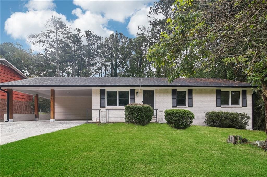 ranch-style home featuring a front yard and a carport