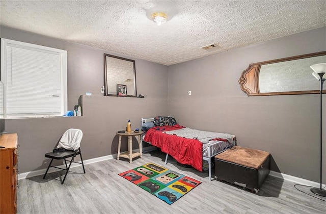 3514 Blackberry Ln SE, Conyers, GA 30094 - bedroom with wood finished floors and a textured ceiling