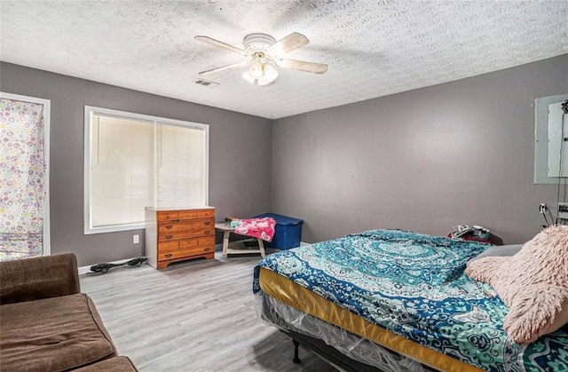 3514 Blackberry Ln SE, Conyers, GA 30094 - bedroom featuring wood finished floors, ceiling fan, and a textured ceiling
