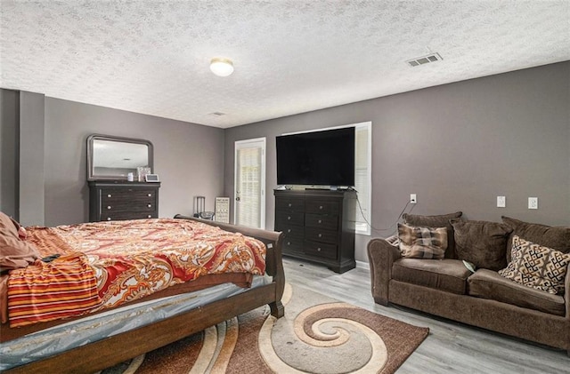 3514 Blackberry Ln SE, Conyers, GA 30094 - bedroom with light wood-style floors and a textured ceiling