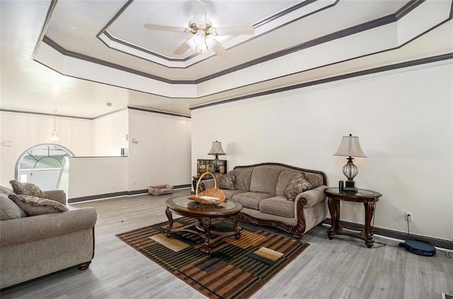 3514 Blackberry Ln SE, Conyers, GA 30094 - living area featuring a tray ceiling, ceiling fan, wood finished floors, and ornamental molding