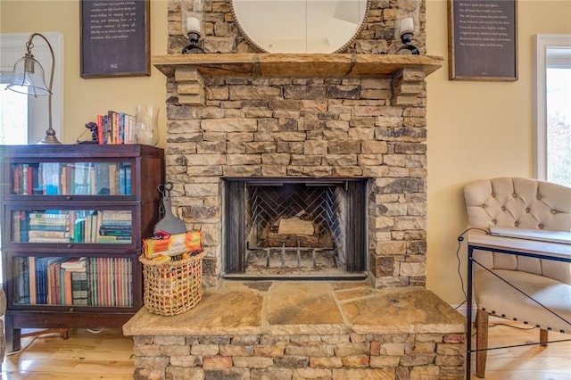 details with a fireplace and light hardwood / wood-style flooring