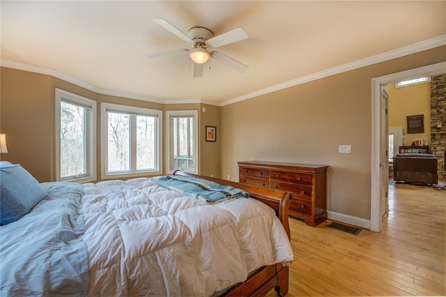 bedroom featuring ceiling fan, crown molding, and light wood-type flooring