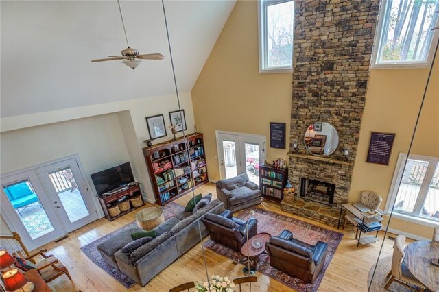 living room with plenty of natural light and high vaulted ceiling