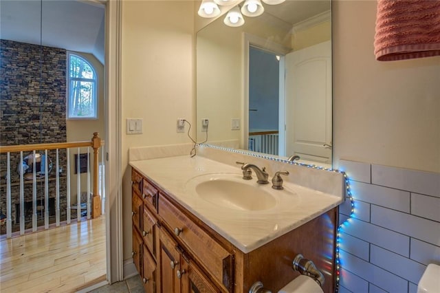 bathroom featuring large vanity and wood-type flooring