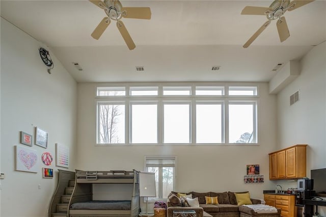 living room with a healthy amount of sunlight and ceiling fan