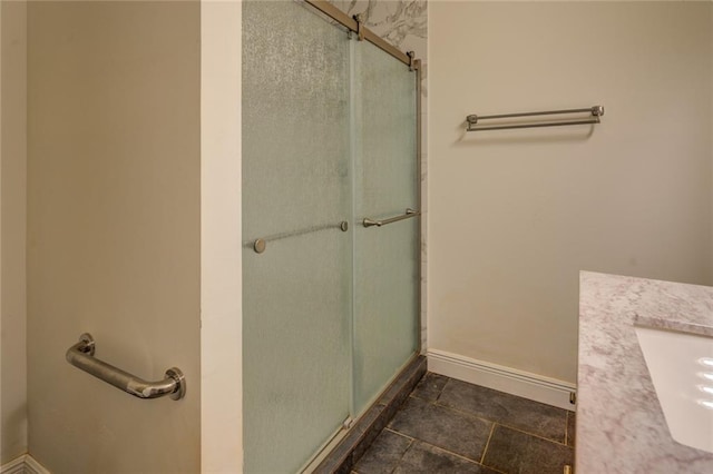 bathroom with vanity, tile flooring, and a shower with door