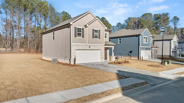 front of property with central AC and a garage