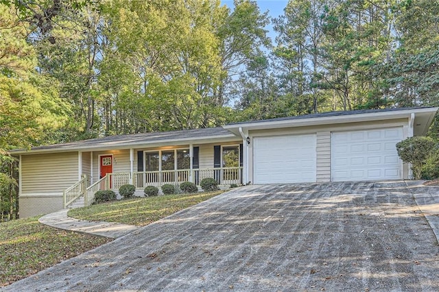 single story home with a porch and a garage