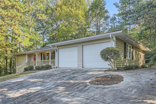 view of front facade with a garage and a porch