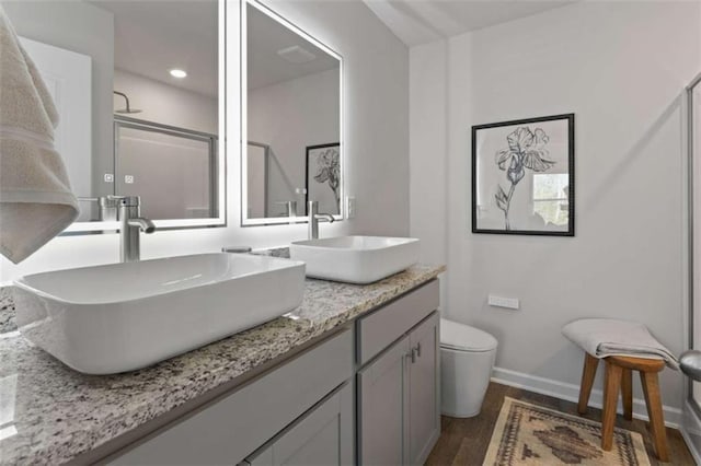 227 Ivey Ter Unit 36, Temple, GA 30179 - bathroom with wood finished floors, double vanity, a shower with door, and recessed lighting