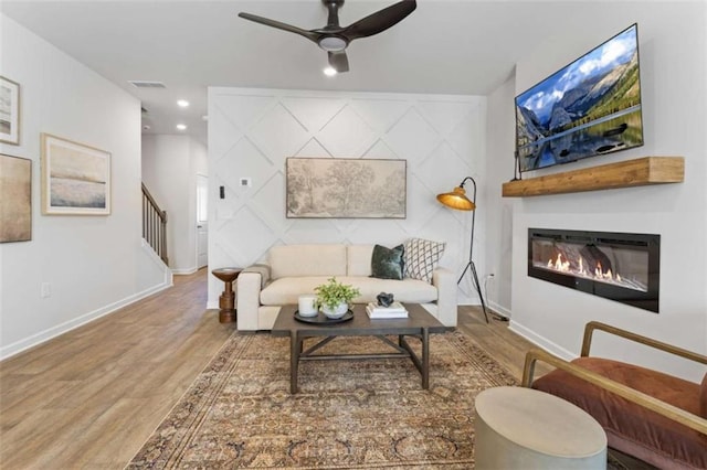 227 Ivey Ter Unit 36, Temple, GA 30179 - living area with wood finished floors, ceiling fan, a glass covered fireplace, stairs, and recessed lighting