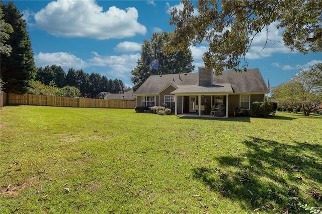 back of property featuring a patio area and a lawn