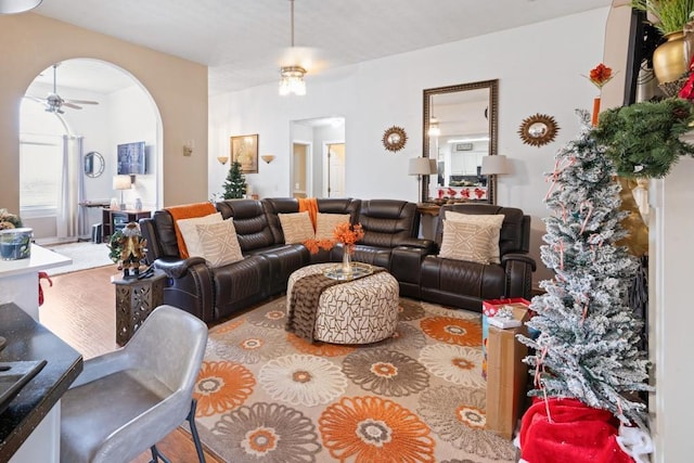 living room with hardwood / wood-style floors and ceiling fan