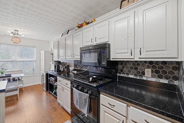 kitchen featuring white cabinets, hardwood / wood-style floors, a textured ceiling, and black appliances