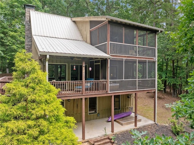 85 Misty Hollow Rdg, Ellijay, GA 30536 - back of property featuring a sunroom, a chimney, a patio, and a metal roof