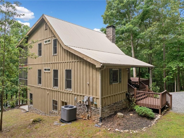 85 Misty Hollow Rdg, Ellijay, GA 30536 - view of home's exterior featuring a chimney, a metal roof, board and batten siding, and a wooden deck