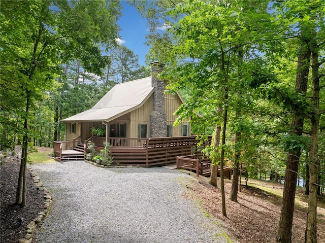85 Misty Hollow Rdg, Ellijay, GA 30536 - view of front of property featuring a chimney, a deck, board and batten siding, and driveway