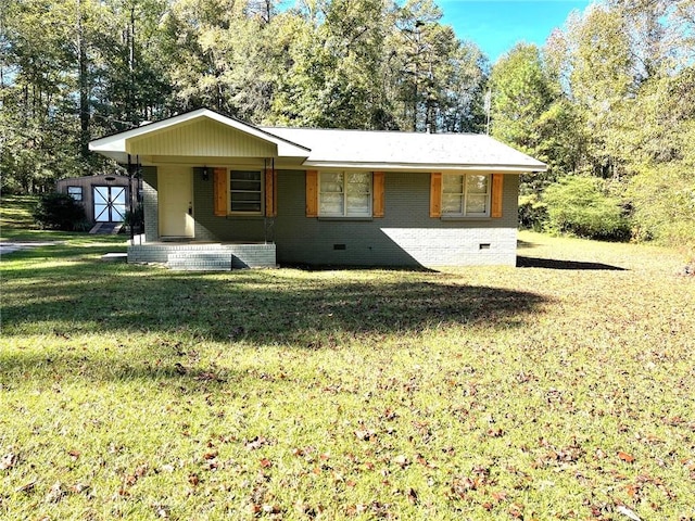 ranch-style home with a front yard and a storage unit