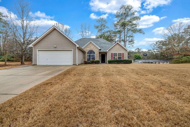 ranch-style house featuring an attached garage, concrete driveway, and a front yard