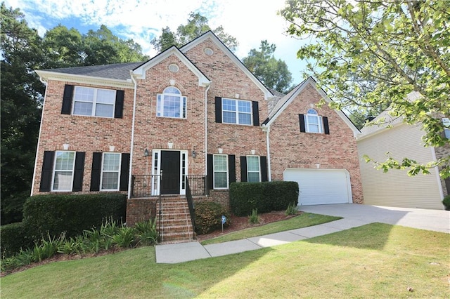 colonial home featuring a front lawn and a garage