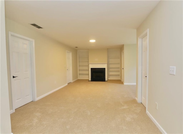 unfurnished living room with light colored carpet