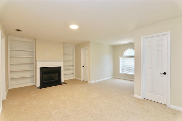 unfurnished living room featuring light colored carpet