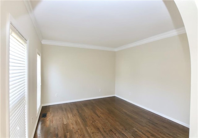 spare room with dark wood-type flooring and crown molding