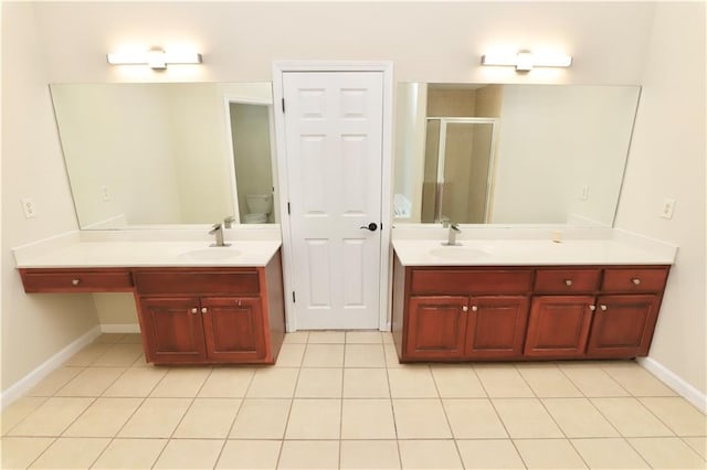 bathroom with toilet, tile patterned floors, walk in shower, and vanity