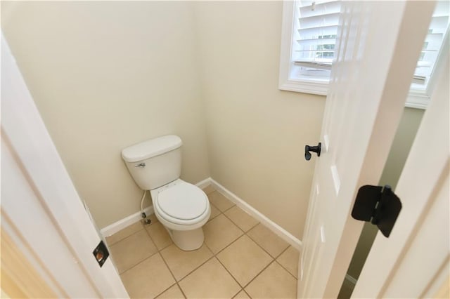 bathroom with toilet and tile patterned floors