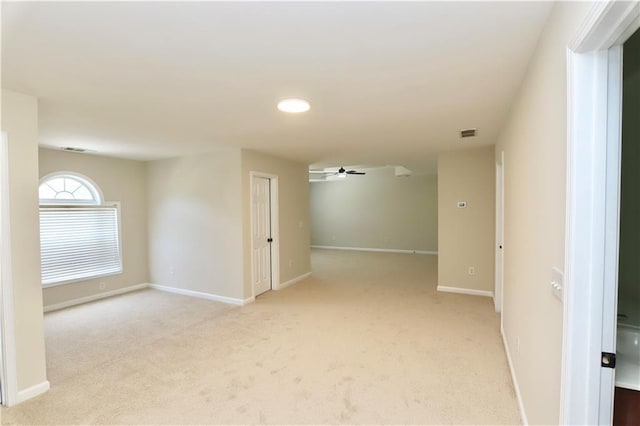 carpeted empty room featuring ceiling fan