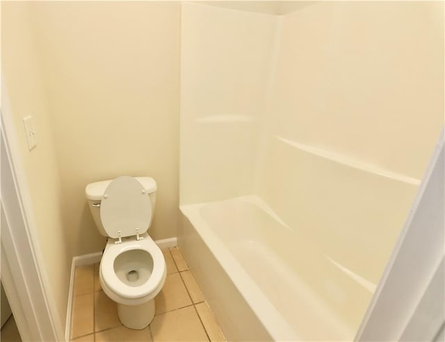 bathroom featuring toilet, tile patterned floors, and a bathing tub