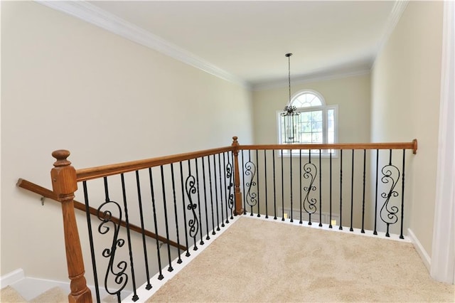 staircase with carpet flooring, ornamental molding, and a notable chandelier