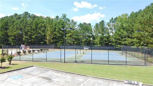 view of sport court featuring a yard