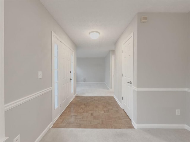 hallway featuring light parquet flooring