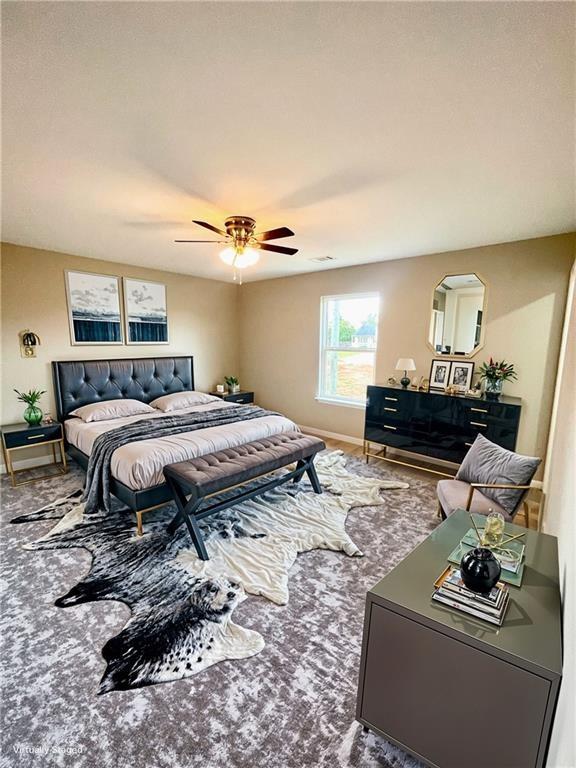 bedroom with ceiling fan and carpet