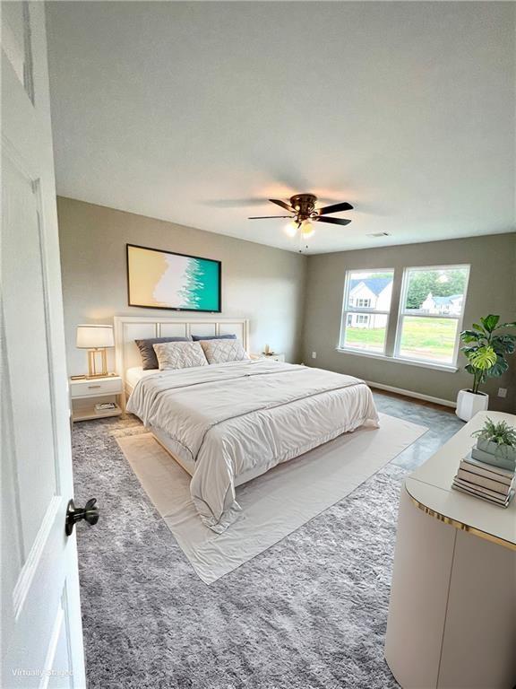 bedroom featuring ceiling fan and light carpet